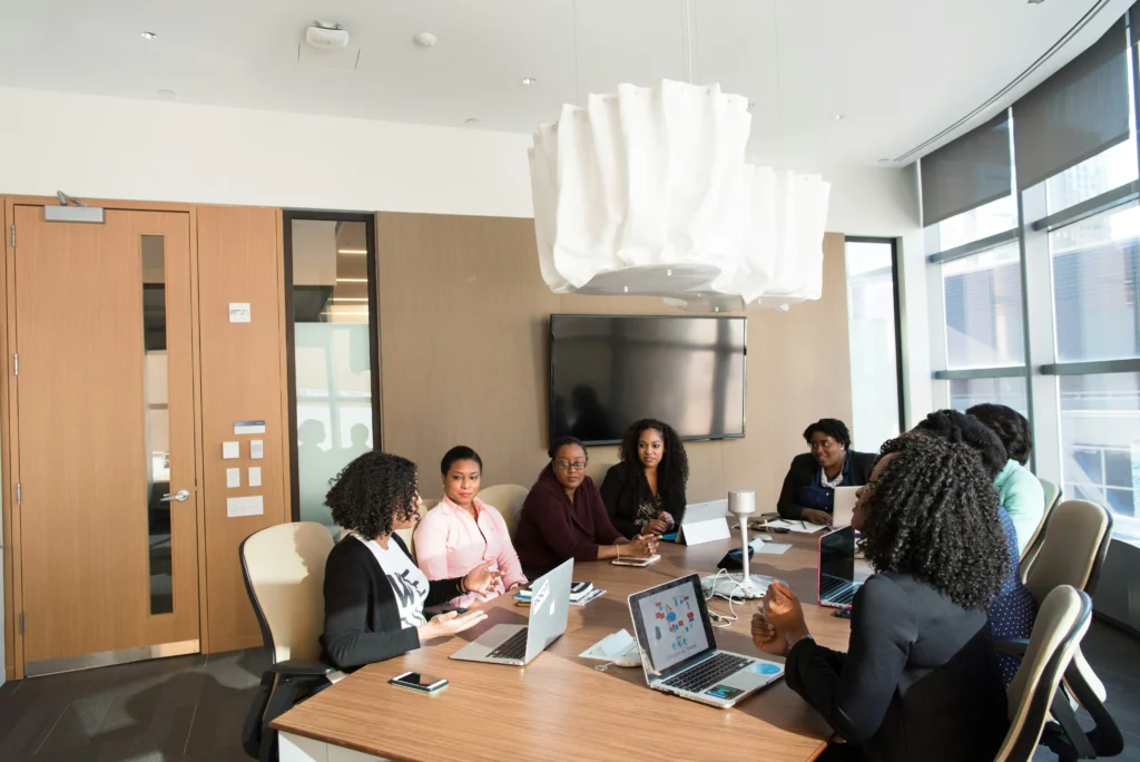 A group of professionals collaborating in a meeting, likely discussing consulting services for energy project fundraising.