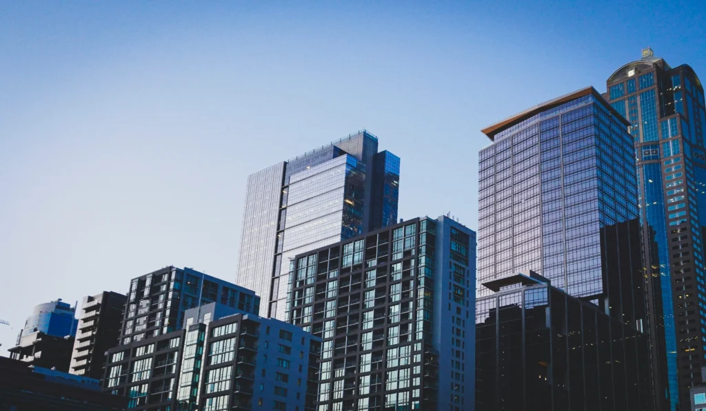 Modern city skyscrapers against a clear sky, symbolizing opportunities in capital raising for off-market real estate.