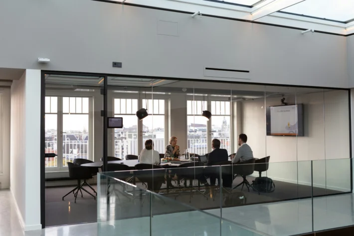 A diverse group of professionals collaborating in a modern office setting, representing organic growth strategies in marketing.