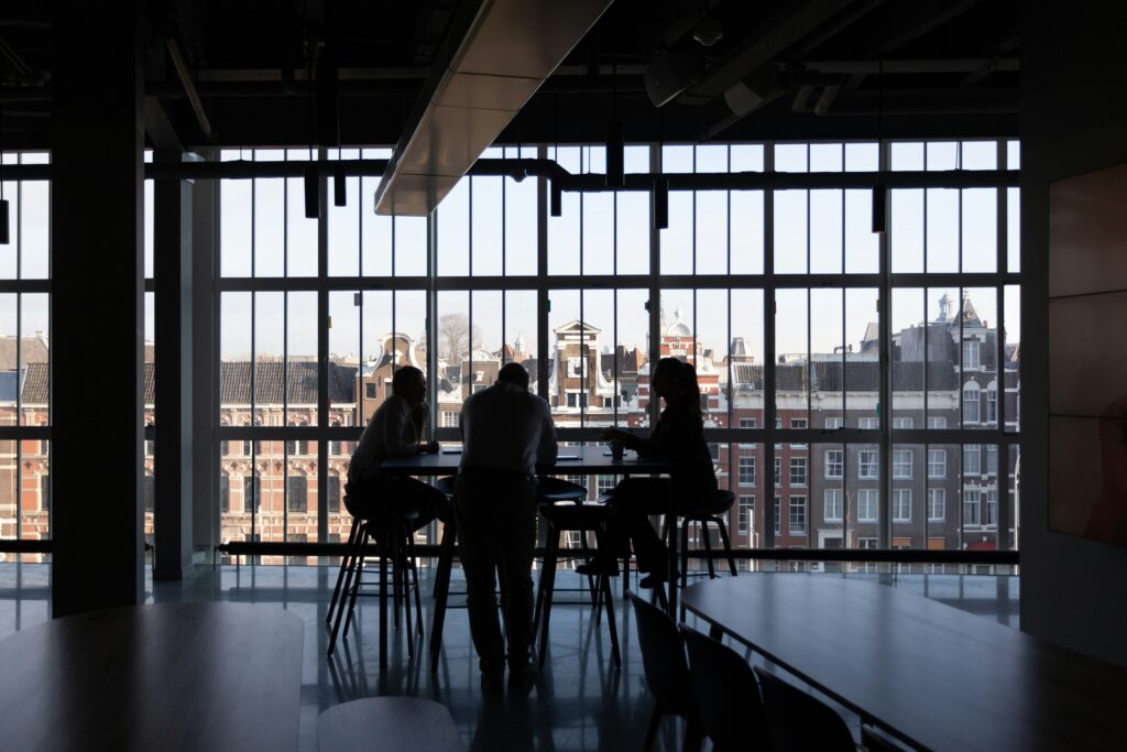 Business team meeting in modern office space with city view — building a capital strategy discussion.